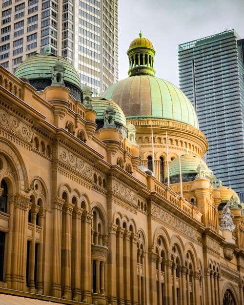 Free A view of the iconic Queen Victoria Building in Sydney amidst modern skyscrapers. Stock Photo