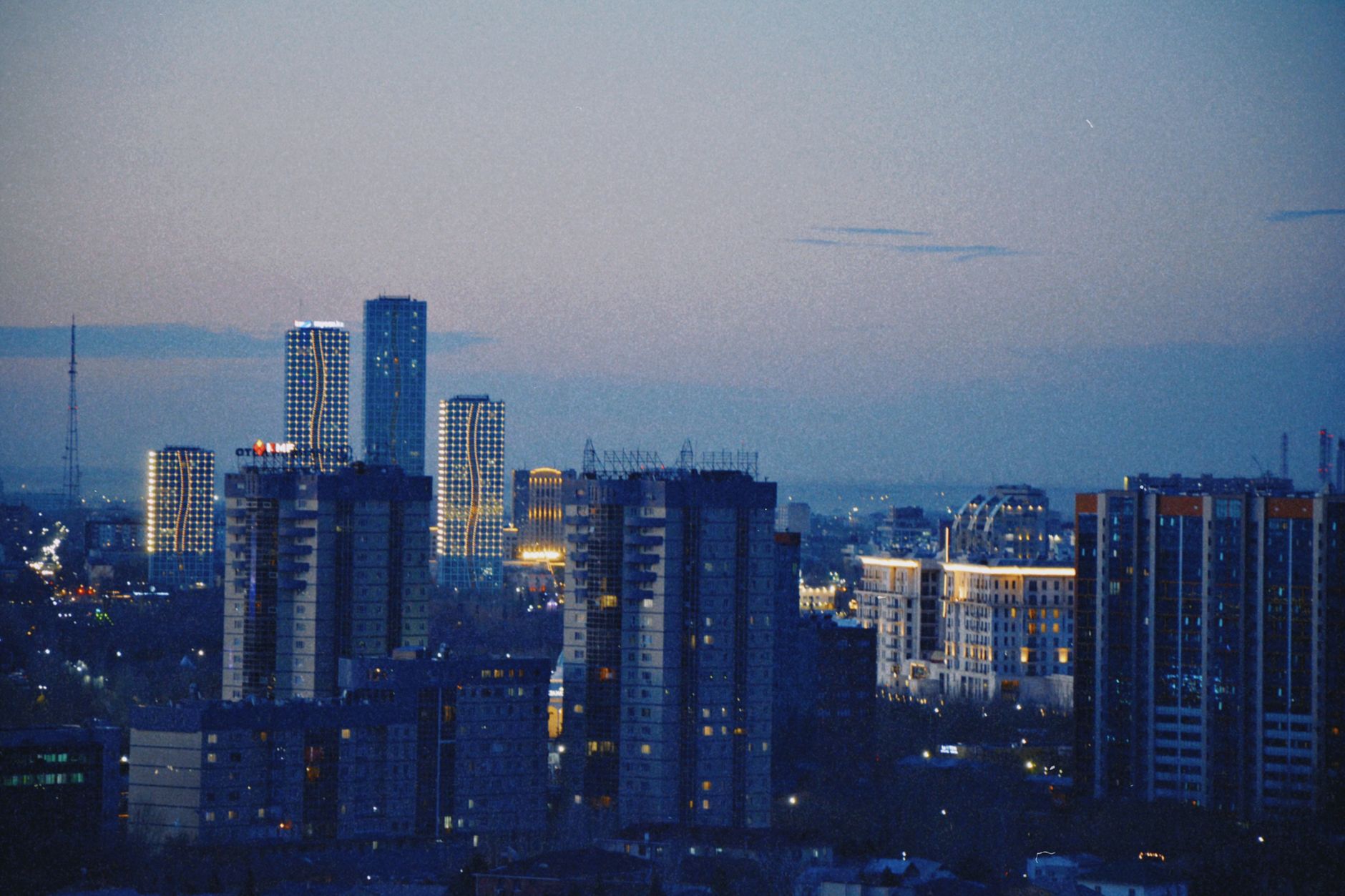 Explore Astana's vibrant skyline at dusk, showcasing modern architecture and a serene cityscape.