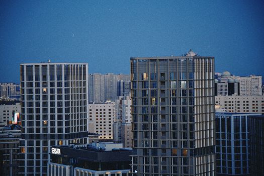 Explore the contemporary skyline of Astana, Kazakhstan, featuring modern skyscrapers against a twilight sky.