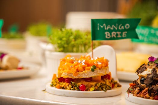 Delicious Mango Brie cheese topped with fresh ingredients and herbs, perfect for elegant dining.
