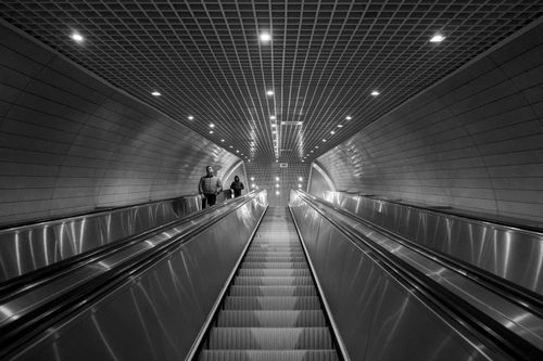 Free Black and white photo of people ascending an escalator in a modern subway station in Istanbul. Stock Photo