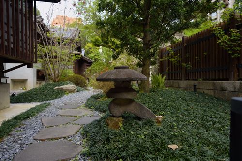 Free Tranquil stone path and lantern in a lush Japanese garden in Taipei. Stock Photo