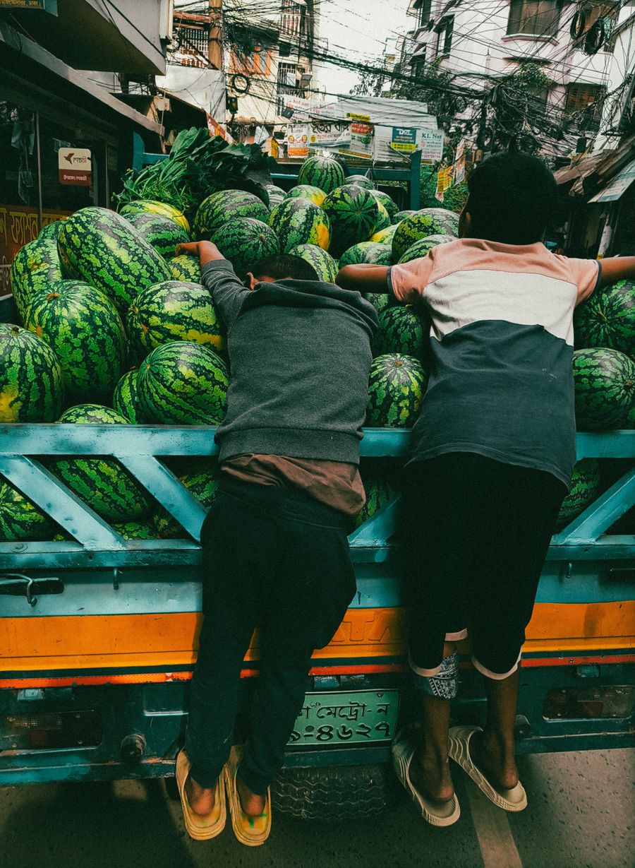 Colorful street scene with watermelon truck in Dhaka