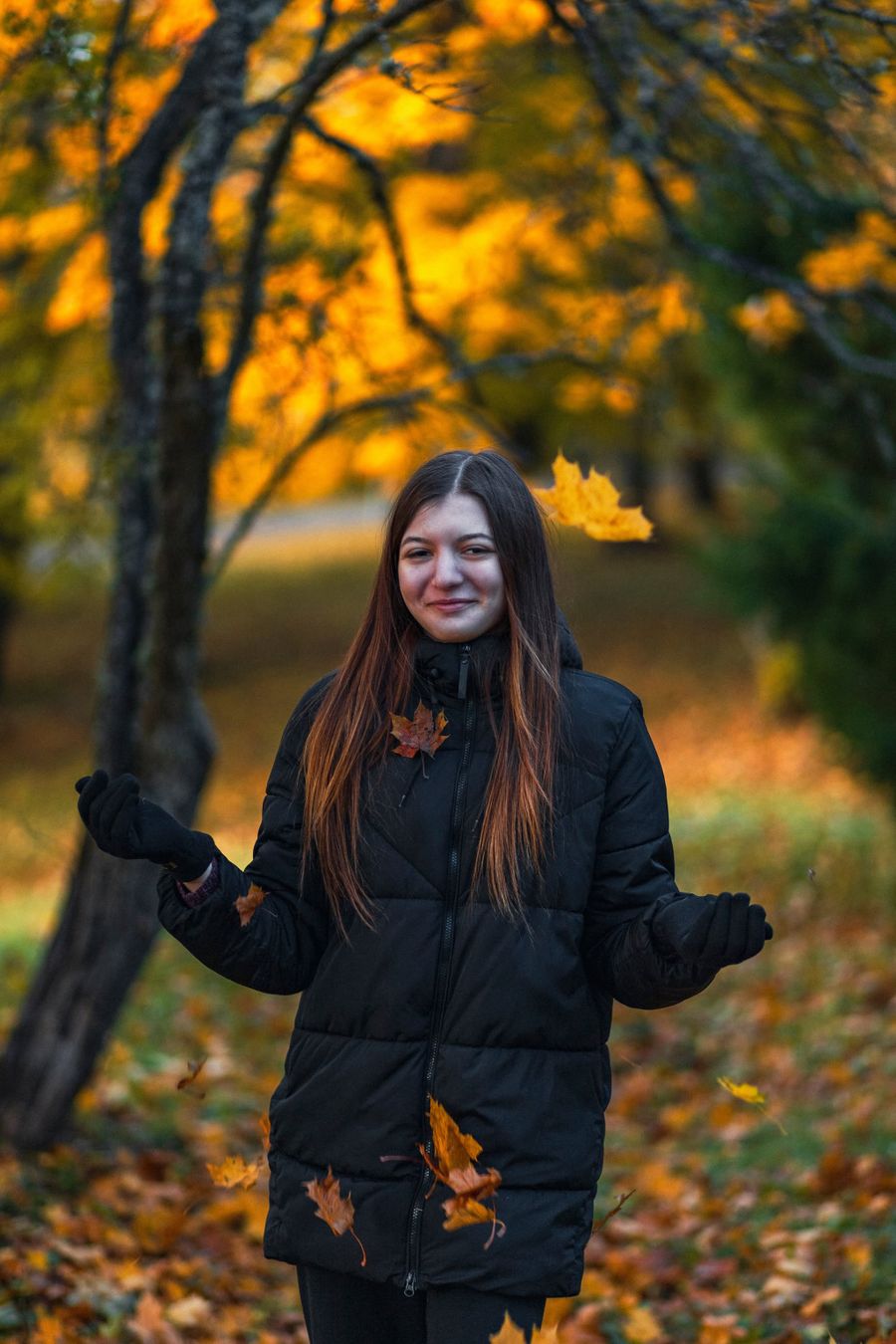 Profile photo: standing among falling autumn leaves in a park — Darja Manuilova on Pexels