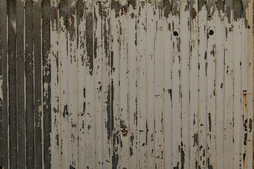 Free Close-up of a weathered metal surface with peeling paint, showcasing rustic texture and decay. Stock Photo