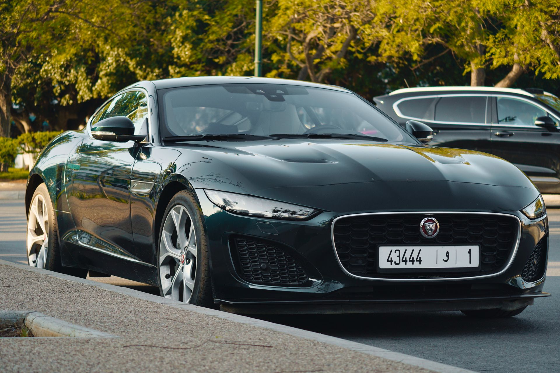 A sleek black Jaguar car parked outdoors in Rabat, Morocco, under the sunny sky.