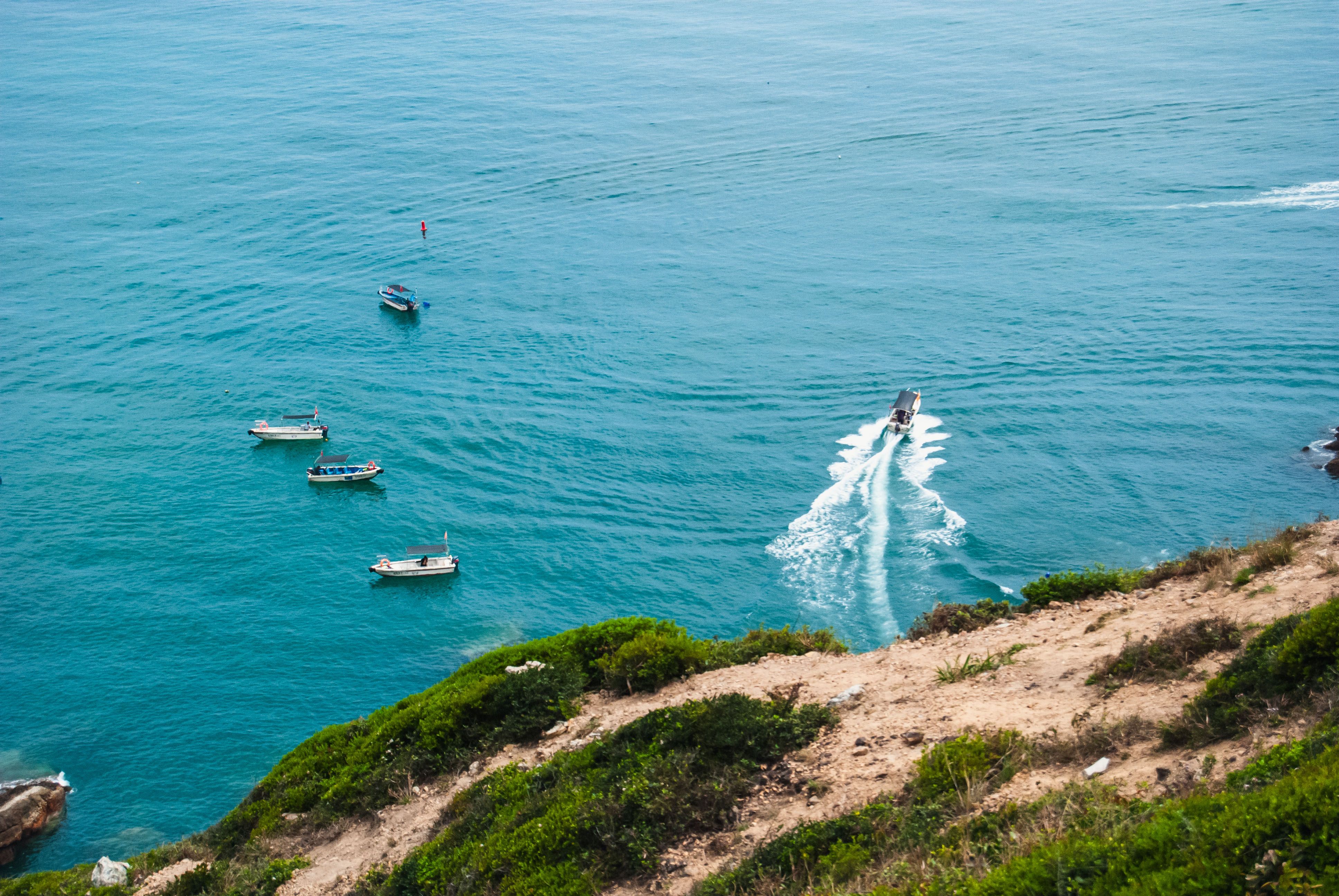 Aerial View of Boats on Vibrant Blue Sea · Free Stock Photo