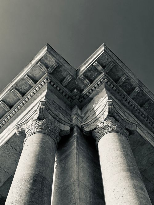 Free Dramatic view of classical architectural columns photographed in black and white. Stock Photo