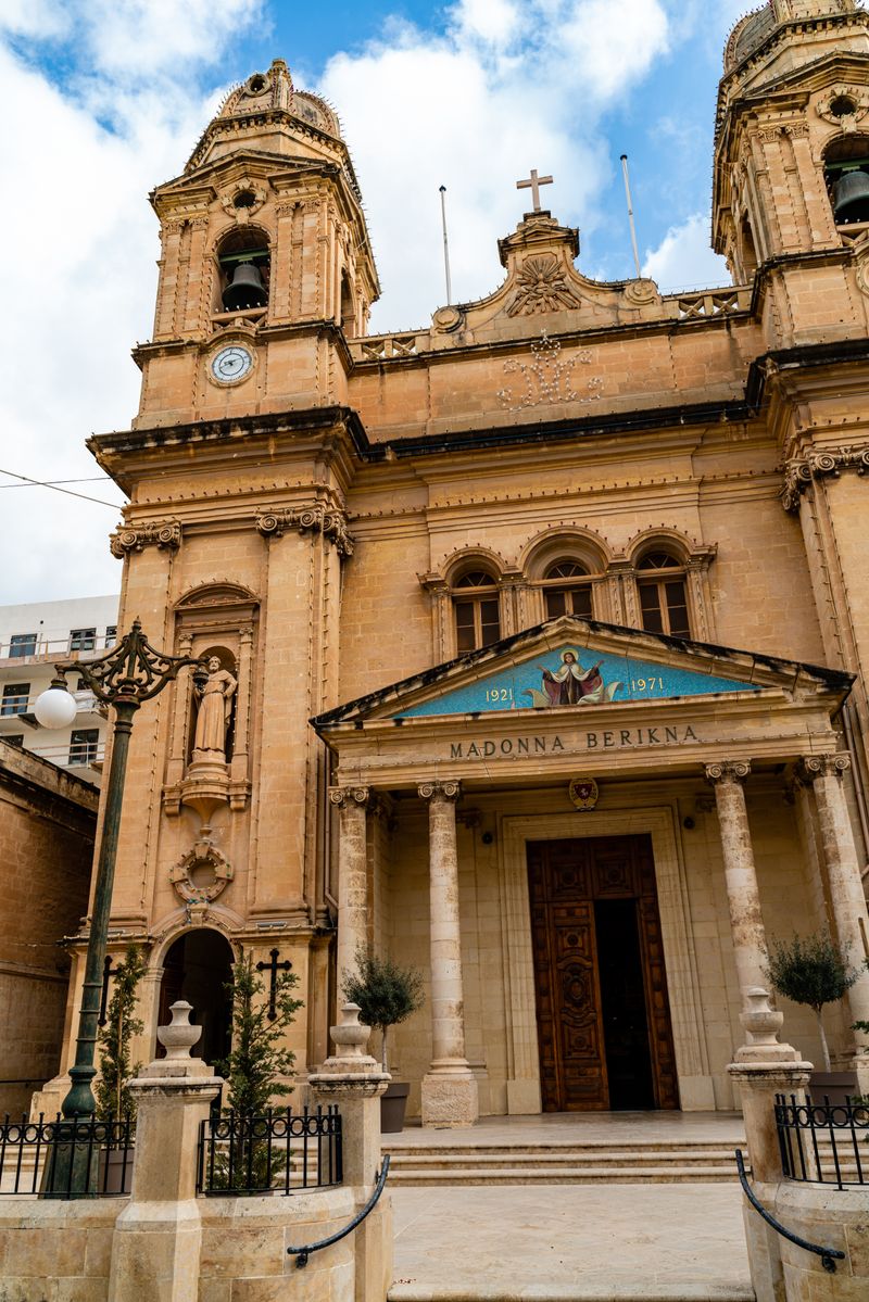 Limestone facade of a historic parish church in Valletta, Malta