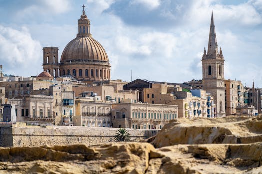 Scenic view of Valletta, Malta, featuring St. Paul's Cathedral under a clear blue sky.