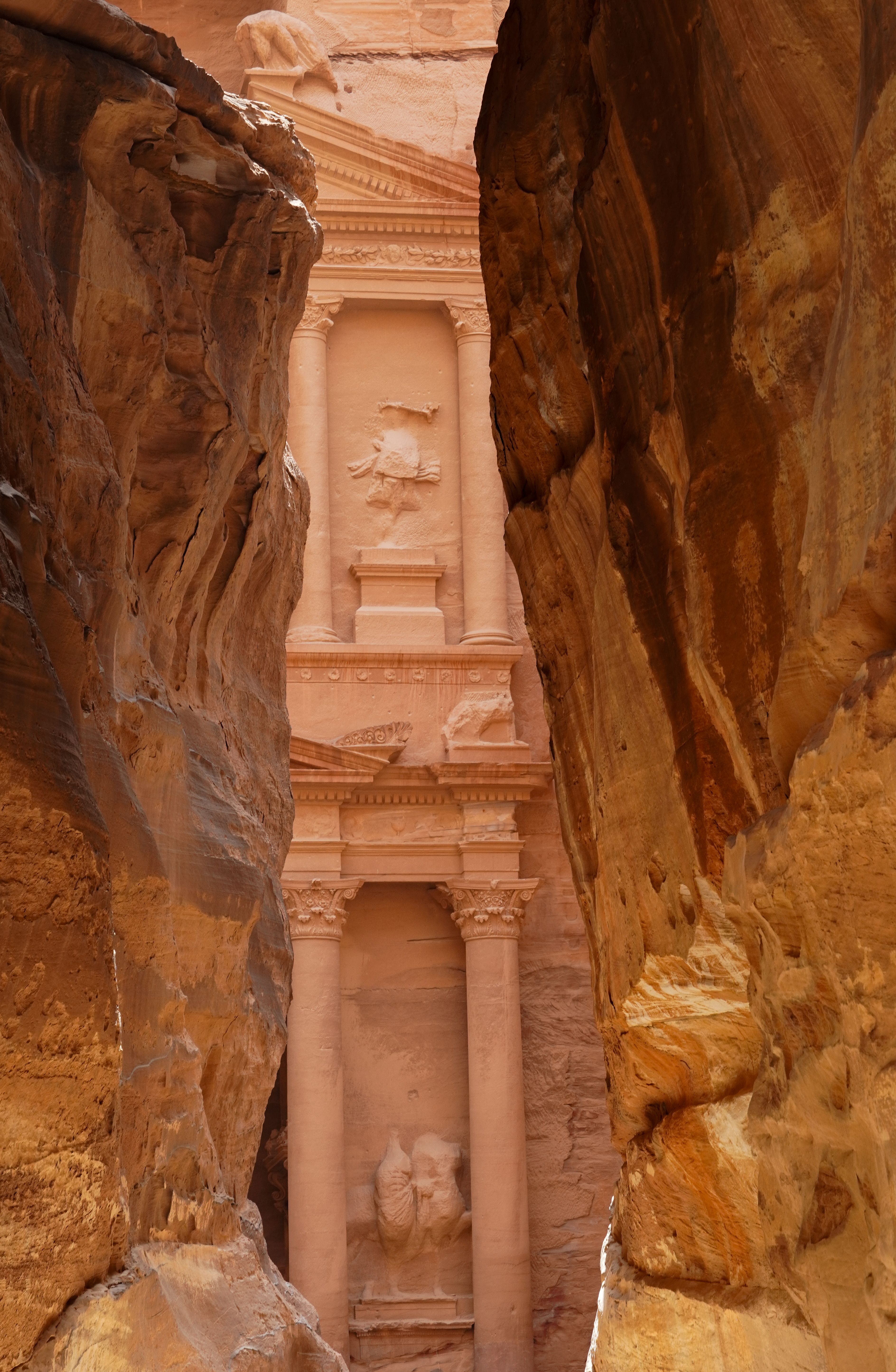 Discover the ancient rock-cut architecture of Petra, seen through the narrow passage of The Siq in Jordan.