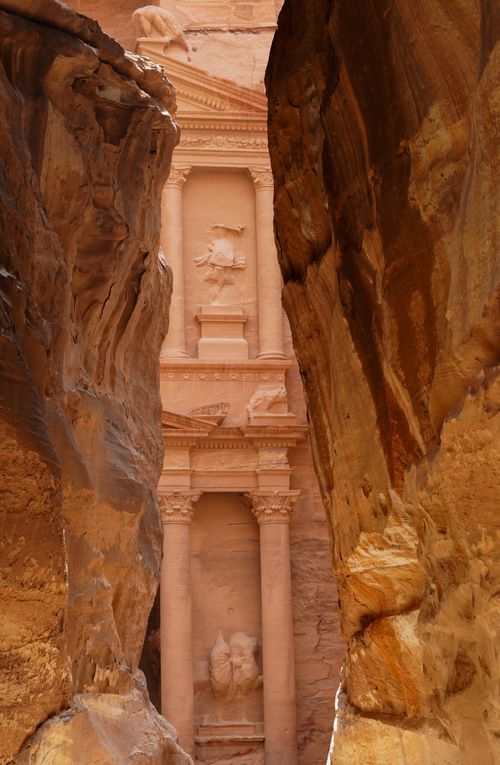 Free Discover the ancient rock-cut architecture of Petra, seen through the narrow passage of The Siq in Jordan. Stock Photo