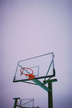 A minimalist view of a basketball hoop set outdoors under a clear sky in China.