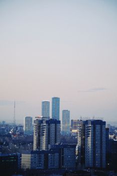 Skyline of Astana with high-rise buildings under a calm evening sky.