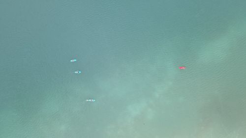 Free Aerial photo showcasing paddleboarders in clear turquoise waters of Quintana Roo, Mexico. Stock Photo