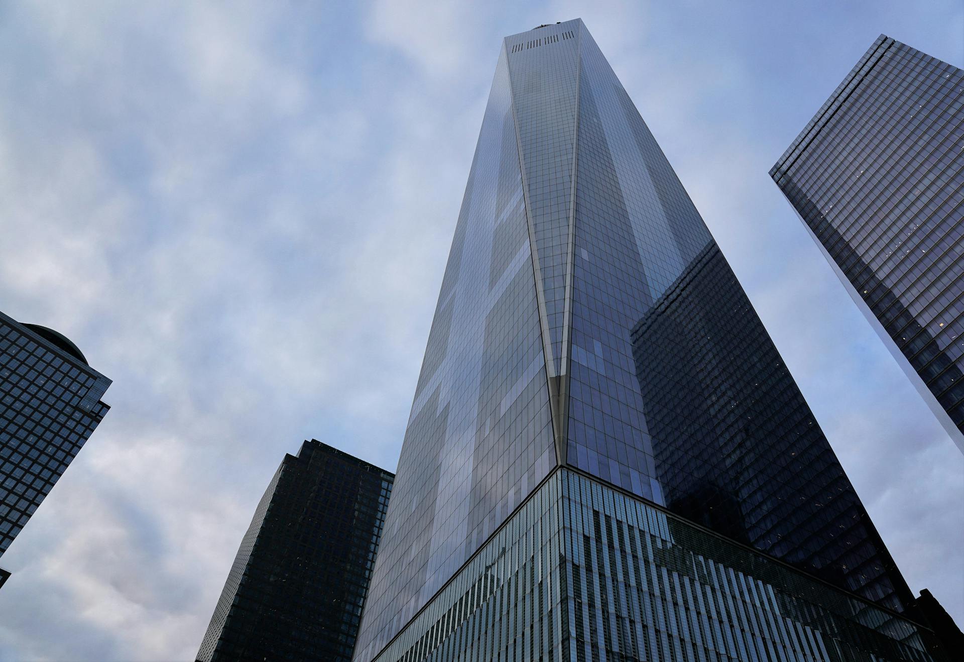 Low angle view of sleek modern skyscrapers against a cloudy sky in downtown Manhattan.