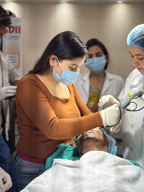 Free Medical professionals perform a cosmetic treatment in a Delhi clinic, focusing on patient care. Stock Photo