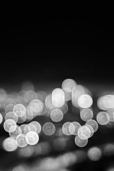Artistic abstraction of city lights as blurred bokeh in black and white.