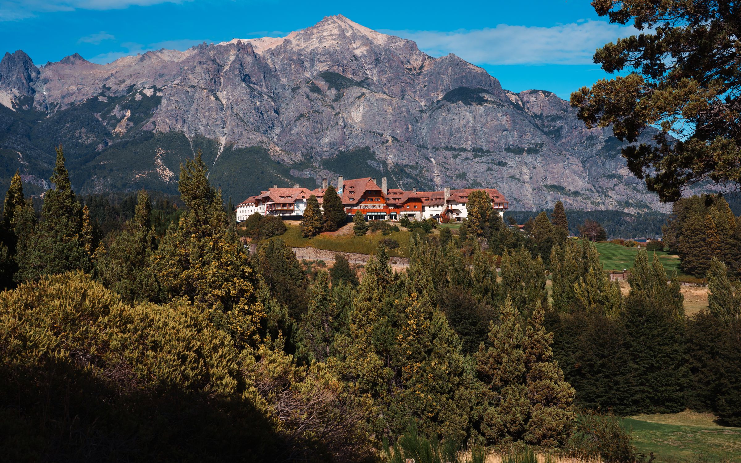 Scenic landscape of Hotel Llao Llao against Andes mountains in Bariloche, Argentina.