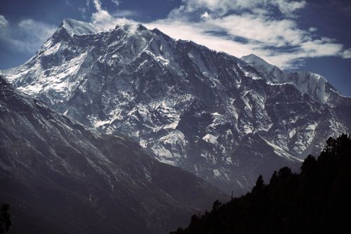 Free Stunning view of a snow-covered mountain range under a cloudy sky. Stock Photo
