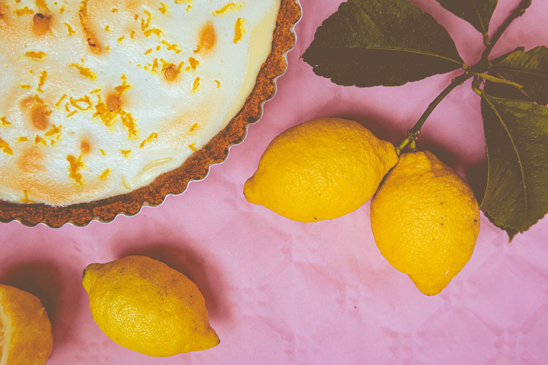 Slice of lemon meringue pie with flaky crust and meringue topping