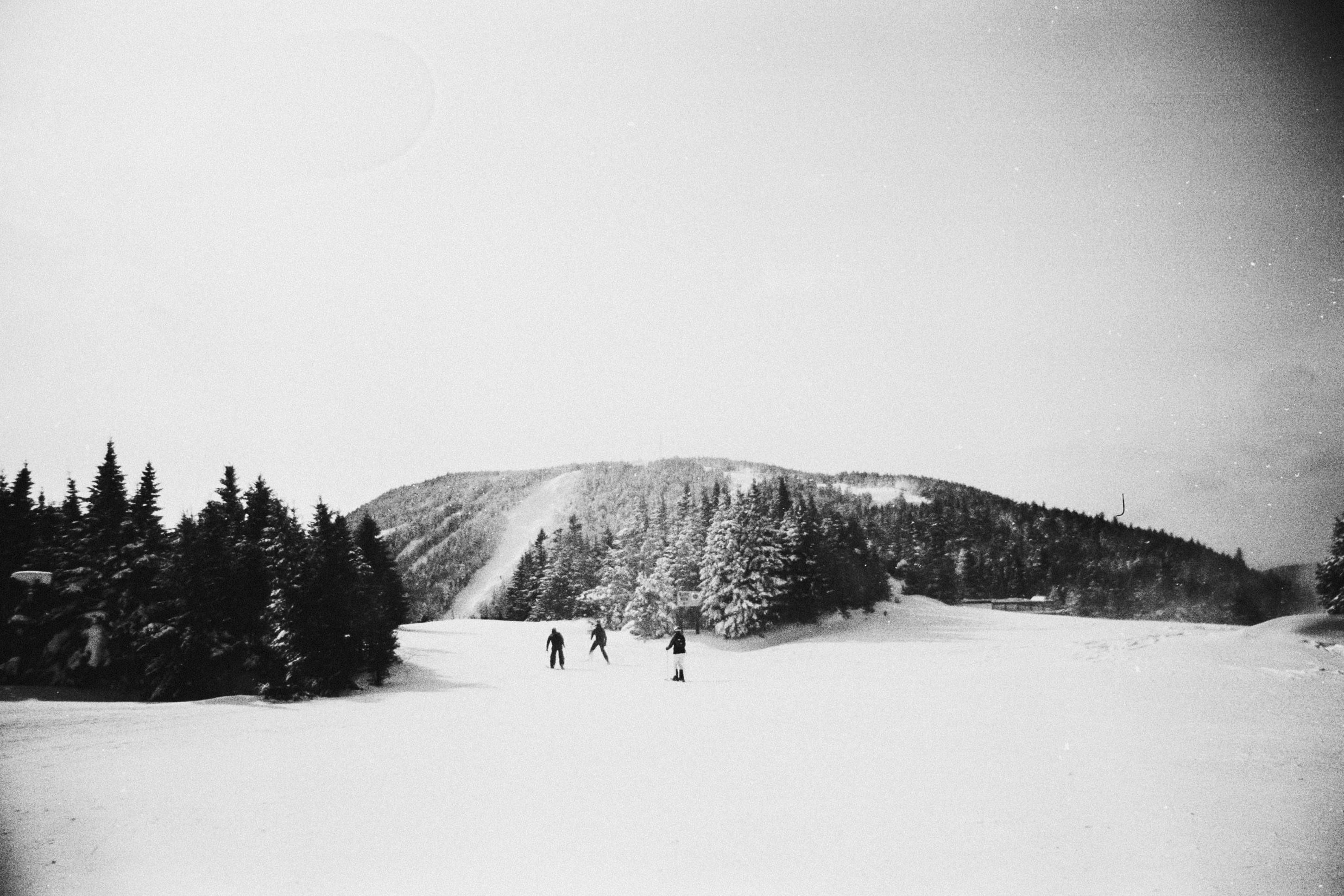 Skiers enjoying a snowy day with a classic black and white touch.