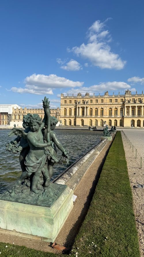 Free Sculpture in the gardens of Château de Versailles under a clear sky, showcasing the palace's grandeur. Stock Photo