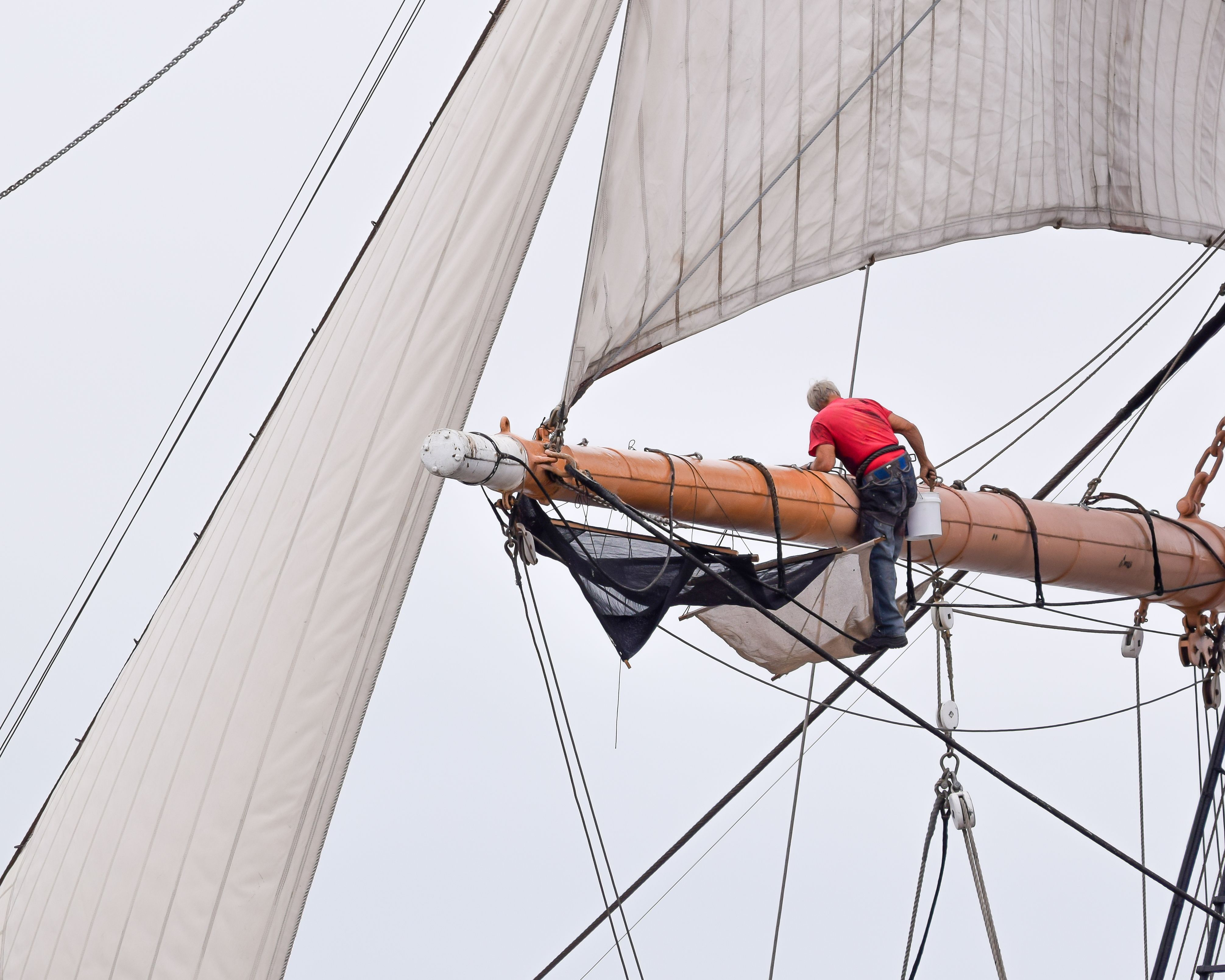 Sailor Performing Maintenance on Tall Ship · Free Stock Photo