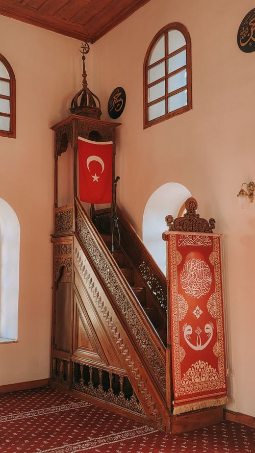 Free Intricately carved wooden minbar with Turkish flag in a mosque interior, Yenipazar, Aydın. Stock Photo