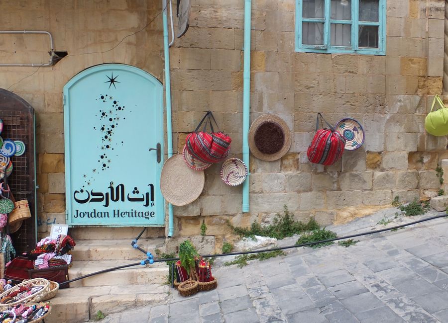 Colorful crafts and souvenirs outside a traditional shop in As-Salt, Jordan.