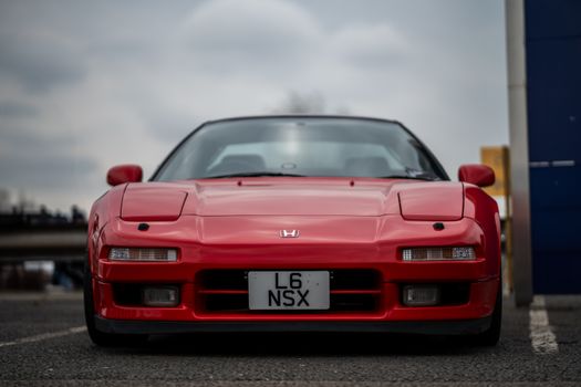 Stunning front view of a classic red Honda NSX, showcasing its iconic design and JDM heritage.