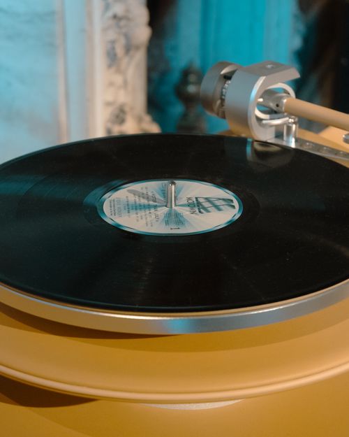 Free A detailed view of a vintage turntable spinning a vinyl record with artistic lighting. Stock Photo