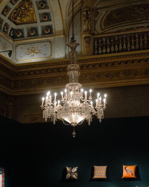 Free A stunning crystal chandelier illuminates a lavish, ornately decorated interior room. Stock Photo