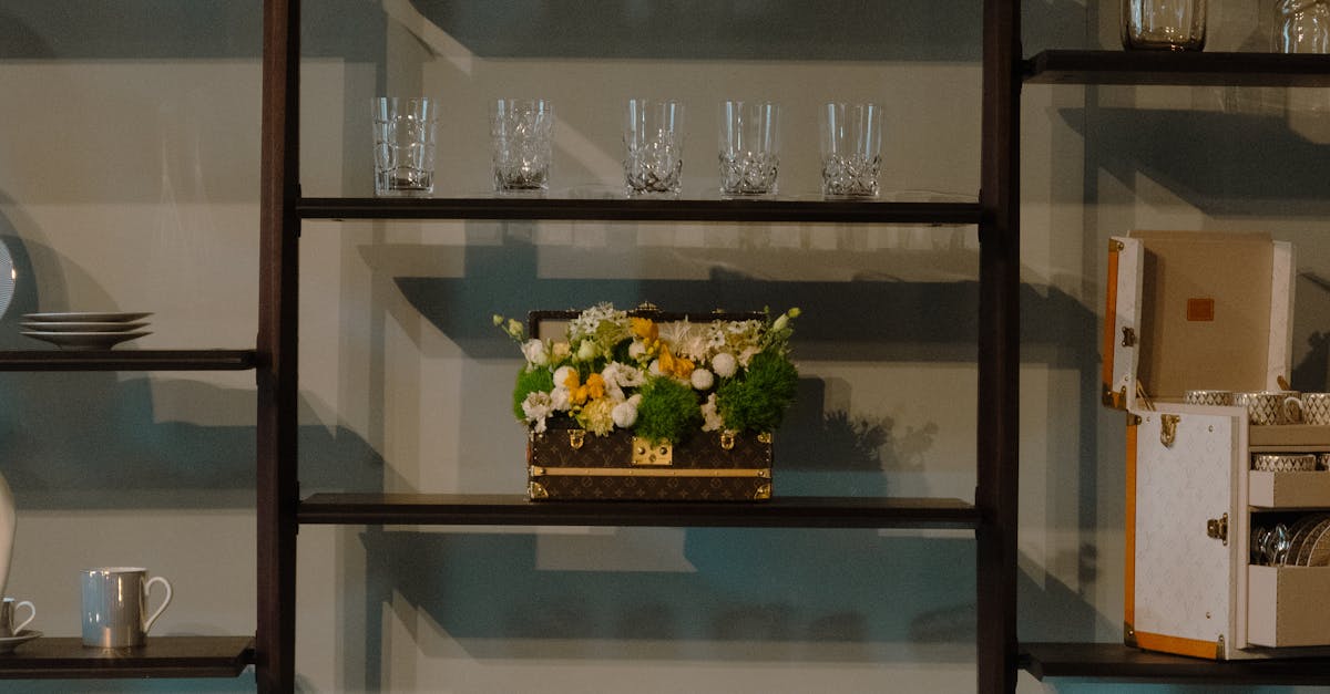 Elegant wooden shelves adorned with glassware, decor items, and a floral centerpiece for a modern interior.