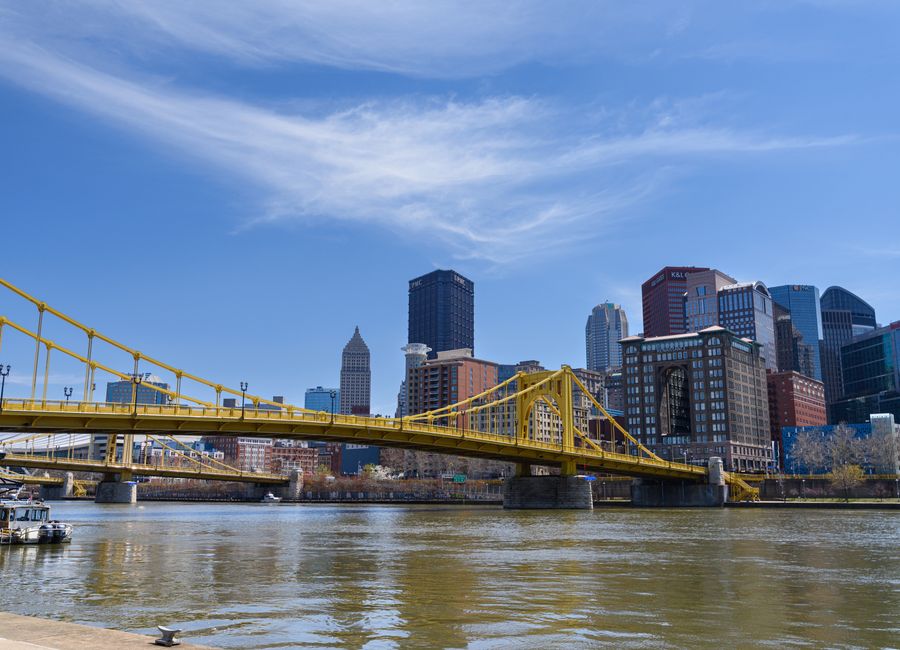 Scenic view of the Pittsburgh skyline featuring the yellow bridge on a clear day.
