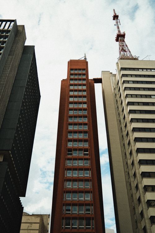 Free High-rise buildings against a cloudy sky showcasing urban architecture and design. Stock Photo