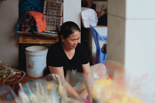 A Vietnamese woman engaged in daily activities indoors in Bình Thuận, Vietnam.