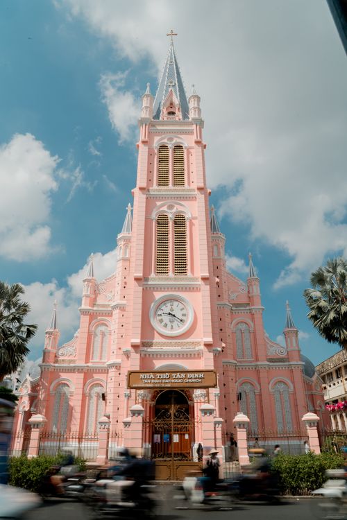 Free Iconic pink Gothic-style church in Ho Chi Minh City under a blue sky. Stock Photo