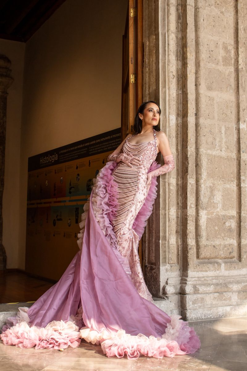 Woman in a pink gown at a historic venue