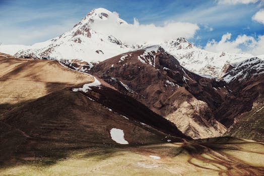A breathtaking panorama of Mount Kazbek in the serene landscape of Georgia's Kazbegi region.