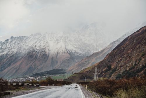 Free A mesmerizing view of the road leading to the misty Mount Kazbek in Georgia's Mtskheta-Mtianeti region. Stock Photo