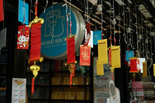 Colorful red and gold lanterns hang at an outdoor market celebrating Lunar New Year.