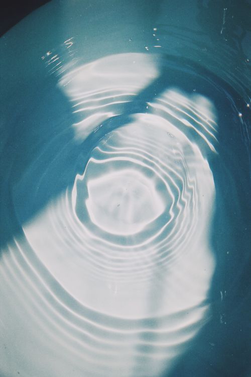 Free Abstract ripples created by sunlight dancing on water surface, casting shadows. Stock Photo