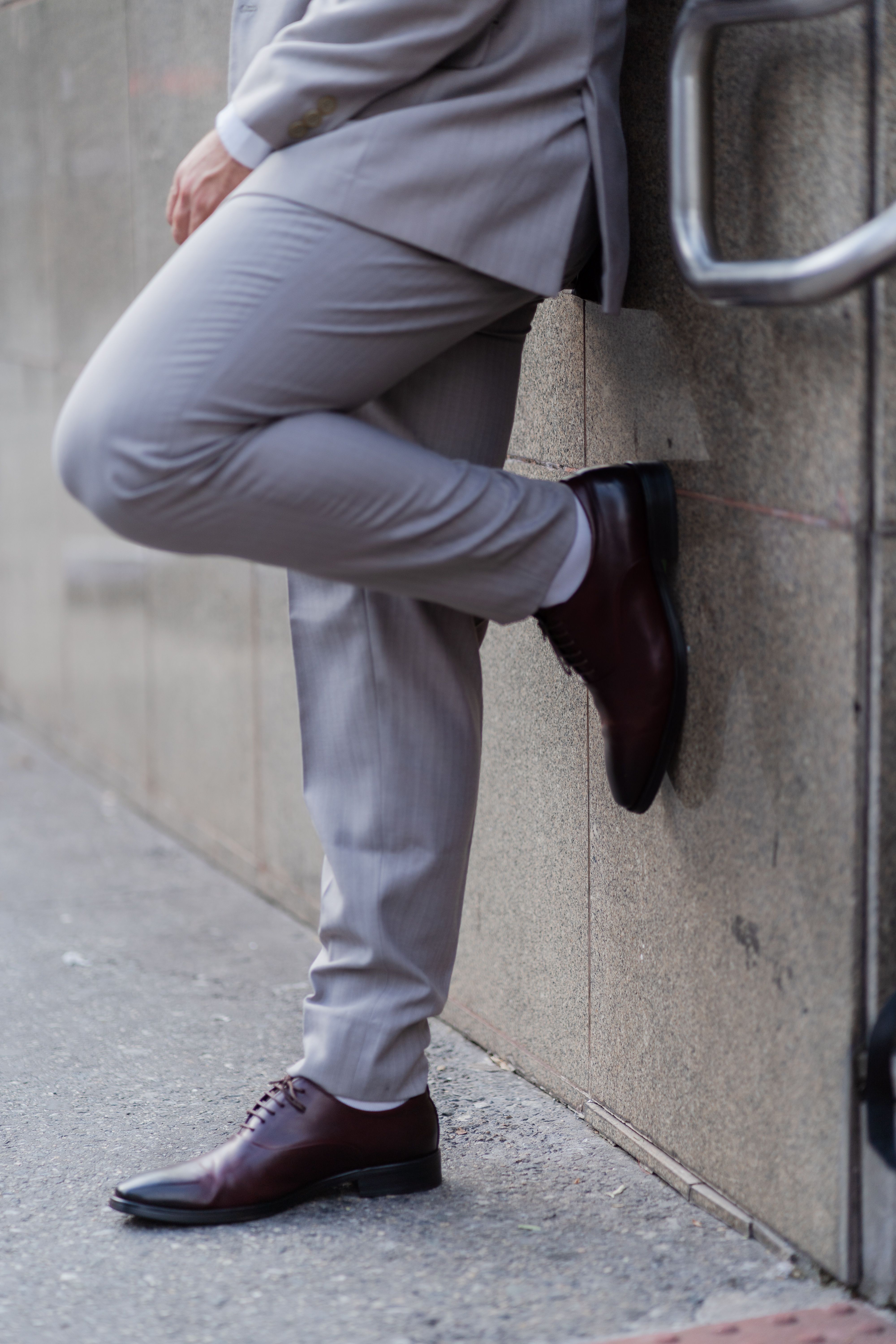 A Person in Gray Pants and Brown Leather Shoes  Free Stock Photo