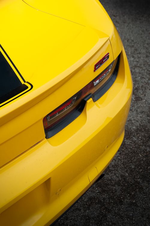 Free Close-up shot of a yellow sports car's sleek rear design with SS badge. Stock Photo