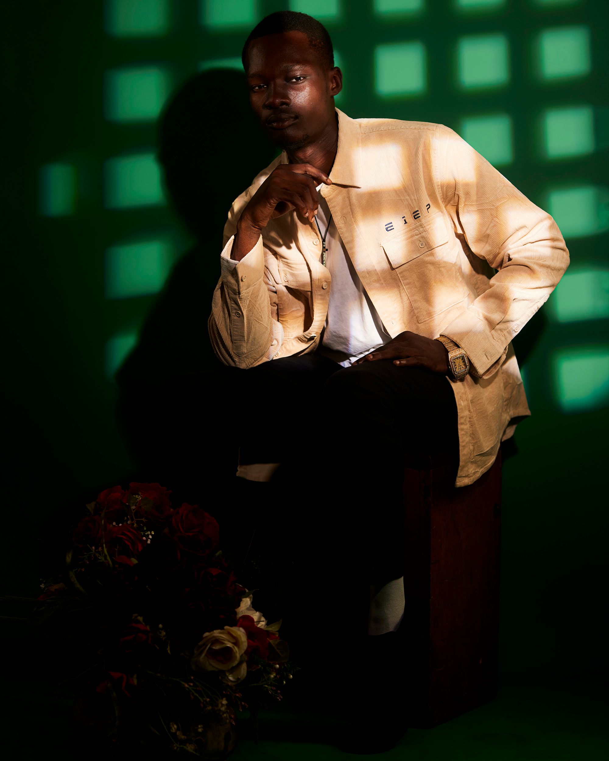Artistic portrait of a man in a studio with dramatic lighting, Kinshasa.