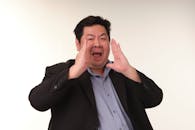 Man in Formal Suit Making a Loud Gesture