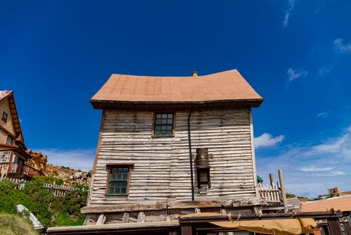 Free Charming wooden house under blue skies in Malta's iconic Popeye Village. Stock Photo