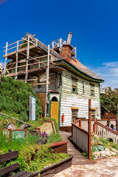 A picturesque wooden house in Popeye Village, showcasing unique architecture under clear blue skies.