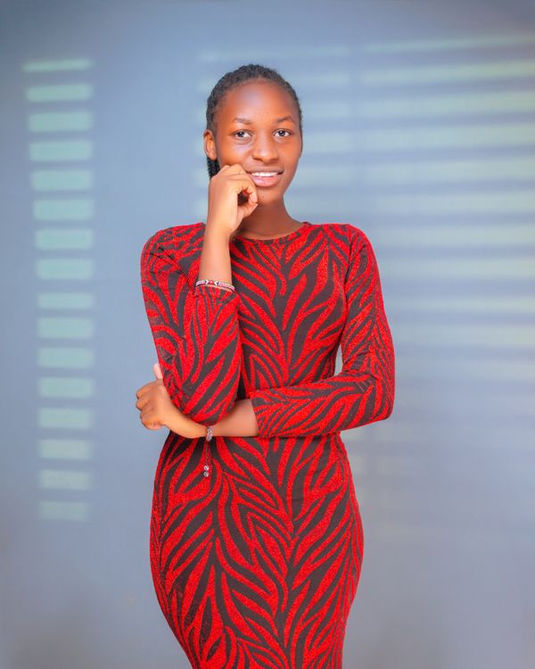 Young Woman Posing in Stylish Red Dress Indoor · Free Stock Photo